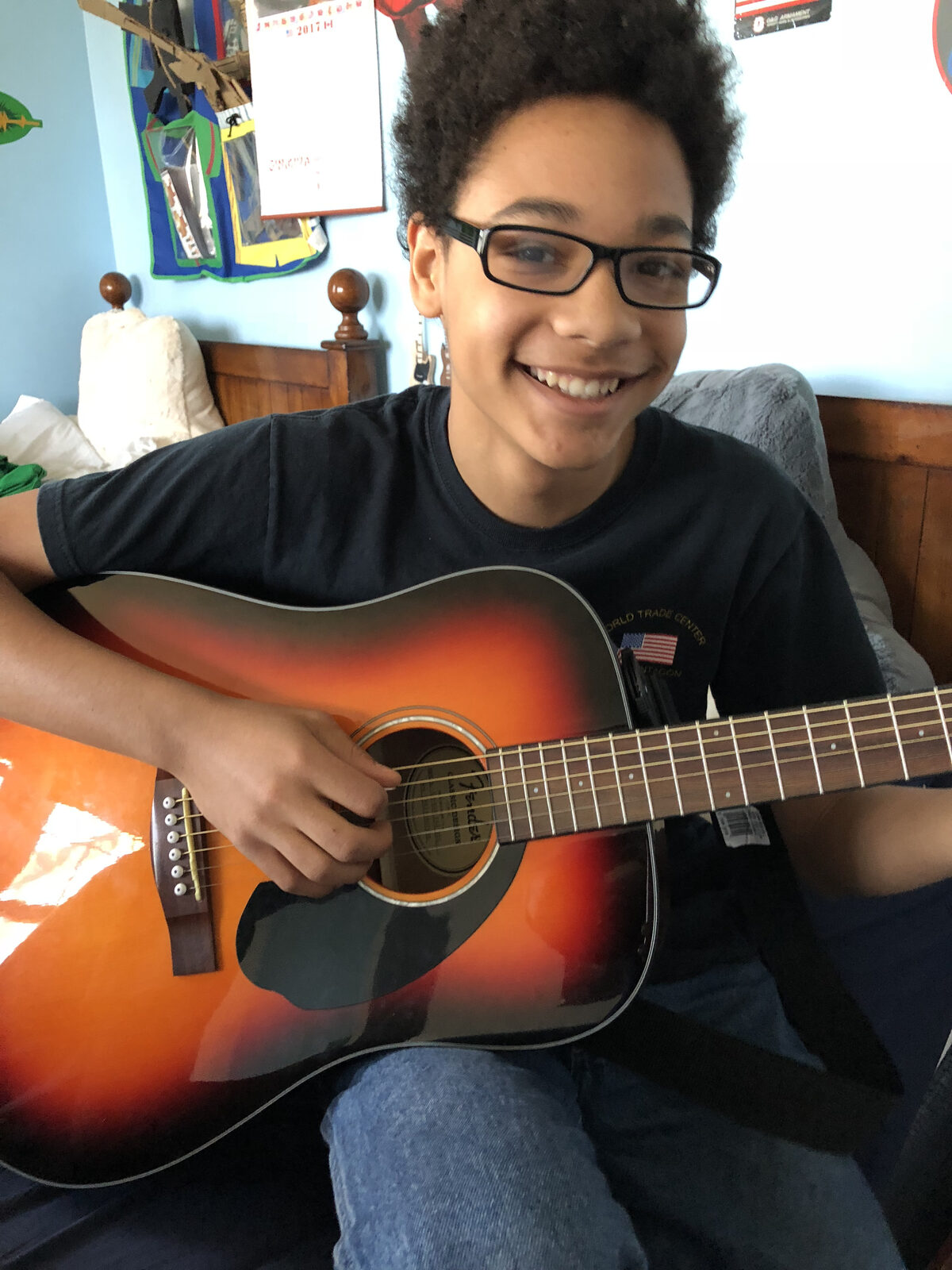 Young Kolin Sawyer playing guitar as a child
