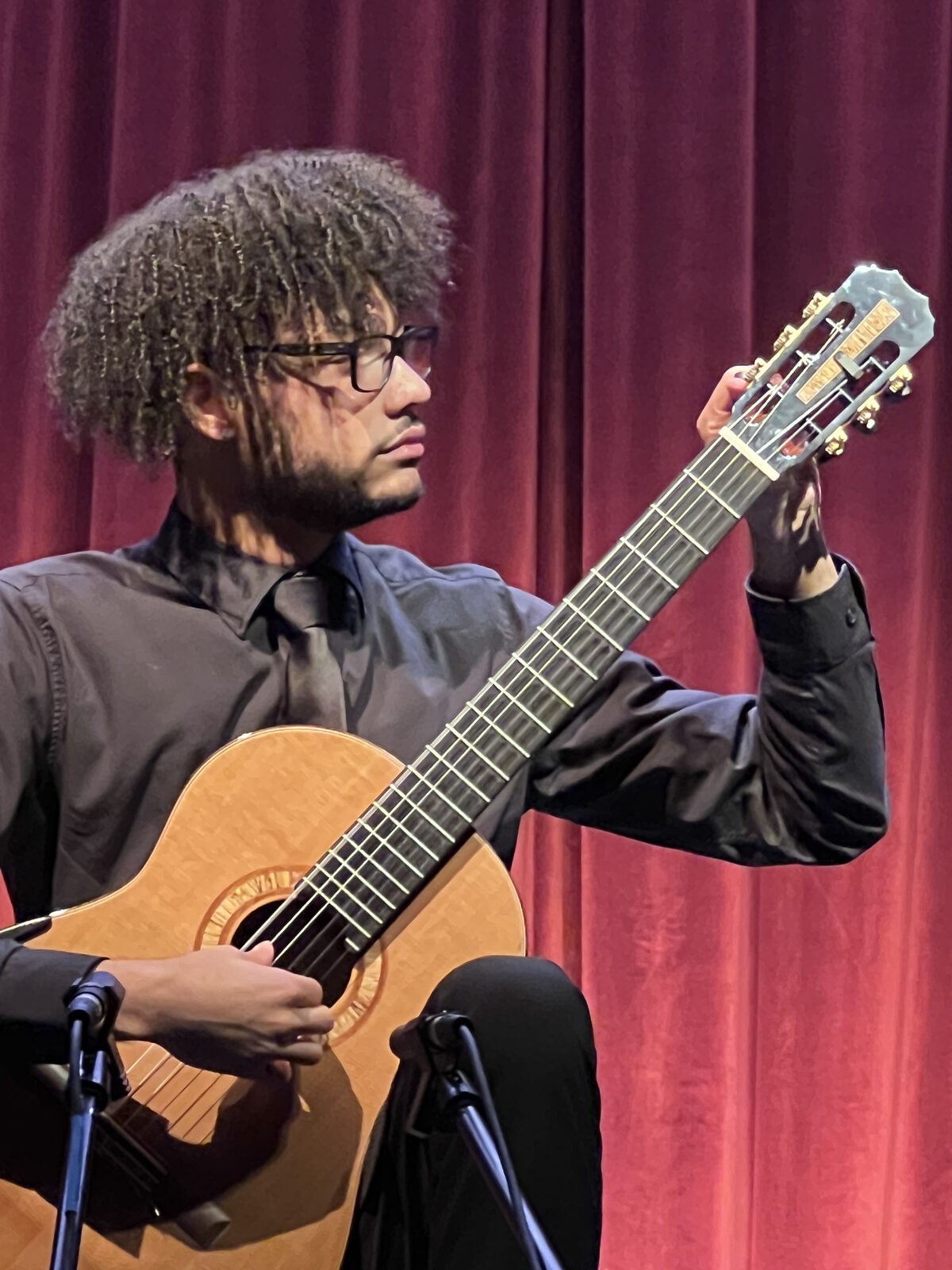 Kolin Sawyer playing acoustic guitar at his recital
